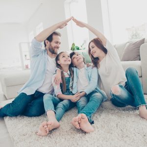 Family in their living room, talking about home insurance policies from Compare Insurance Ireland.
