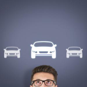 Man under five white cars thinking about buying a car insurance policy with a policy excess.
