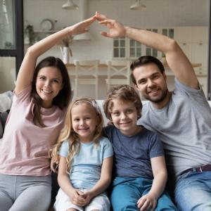 Family on a sofa discussing All Risks cover on their home insurance policy.