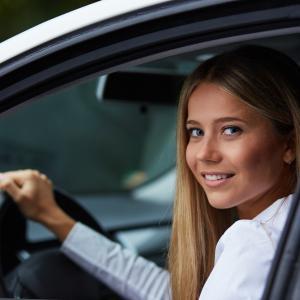 Girl driving a white vehicle with Third Party Fire and Theft car insurance from Compare Insurance Ireland.