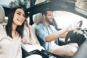 Man and a woman driving in Ireland with a no claims bonus protection on their insurance policy.