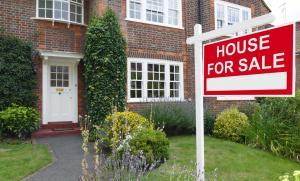 House with for sale sign, mortgage protection