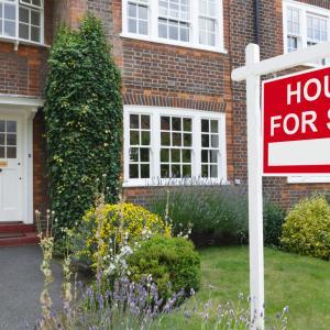 House with for sale sign, mortgage protection