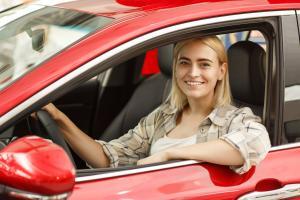 Woman driving a red car