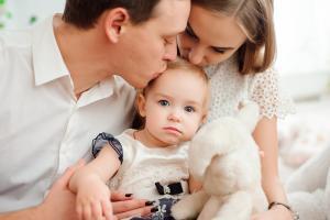 father and mother with baby covered by a whole of life insurance policy