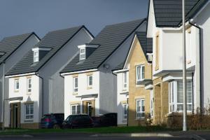 Storm proof houses in Ireland with dark storm clouds in the background
