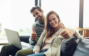 couple on sofa review their house insurance in ireland