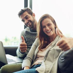 couple on sofa review their house insurance in ireland